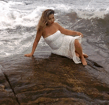 Girl getting hit by a wave