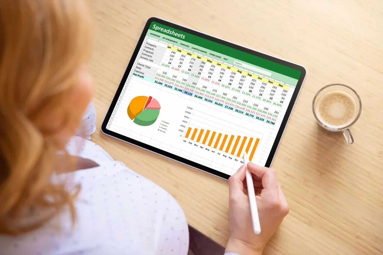 A spreadsheet and a monthly chart being worked on a tablet